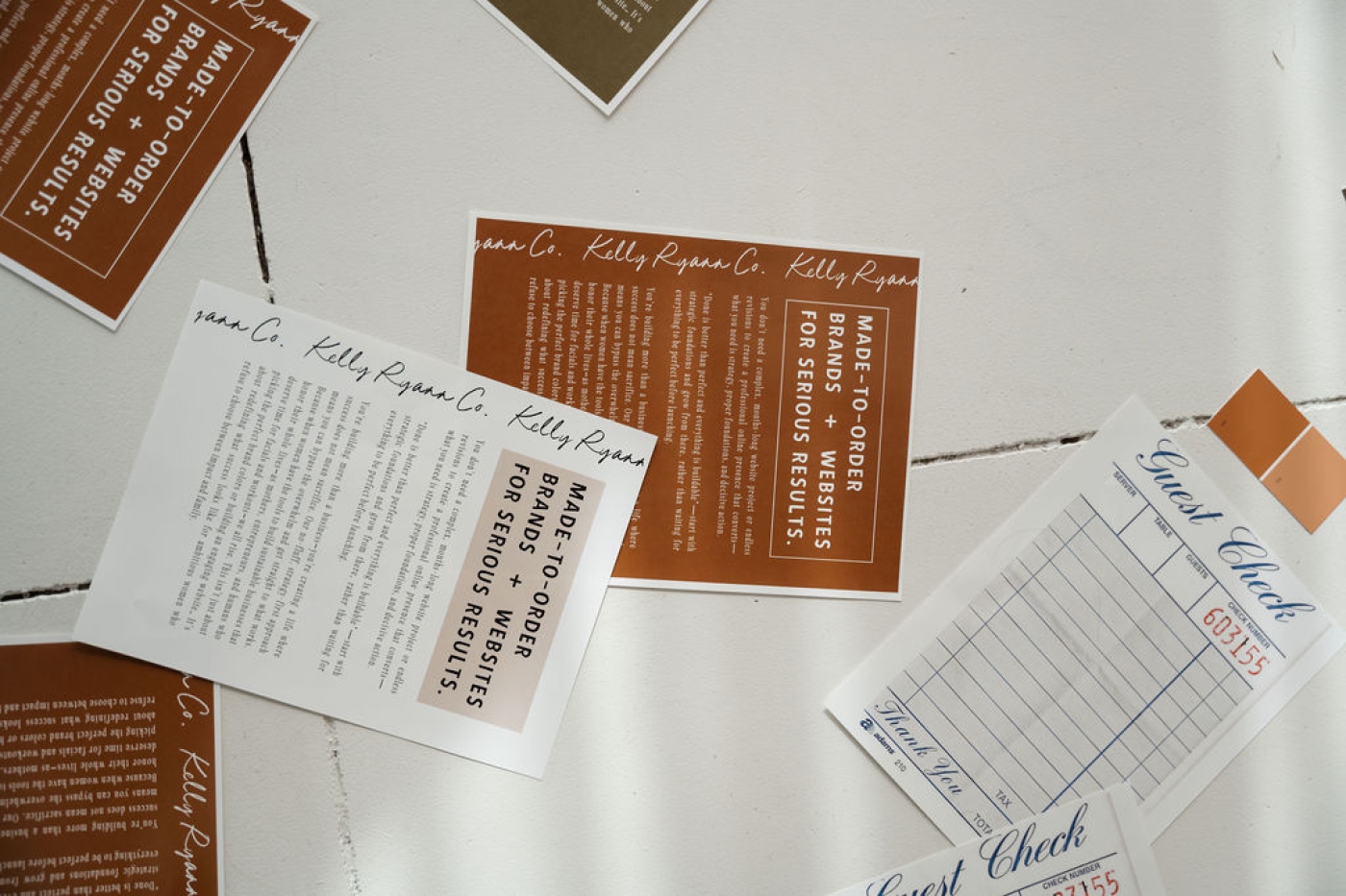 A flurry of papers on a white tile floor